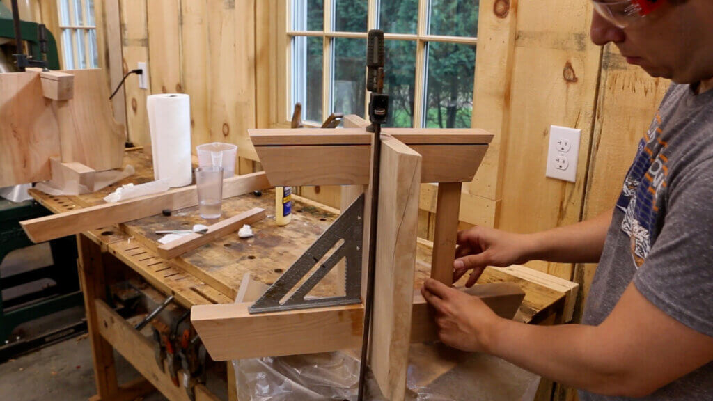 Gluing and clamping the base of the live edge coffee table.