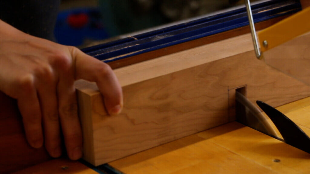 Cutting the live edge coffee table cross support notches.